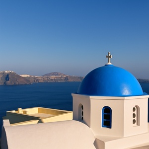 Blue dome building in Santorini with sea background
